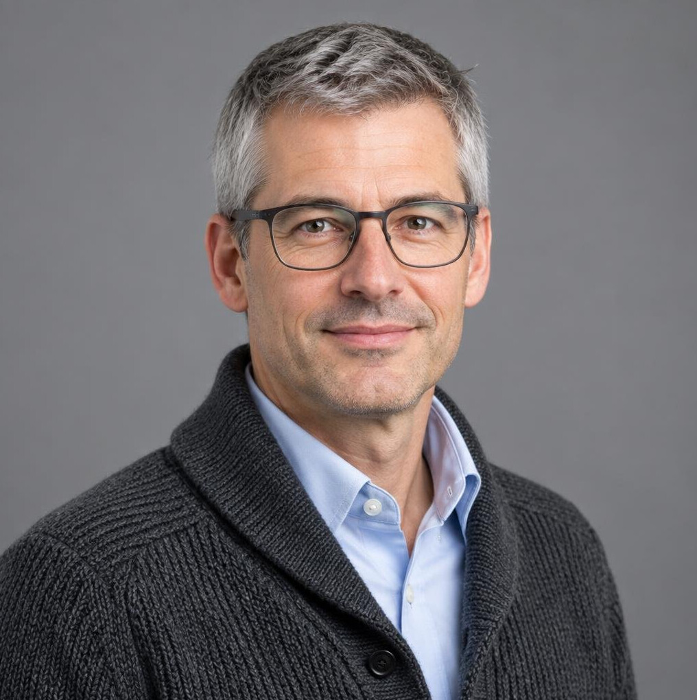 Studio portrait of a Swiss man in his forties with glasses